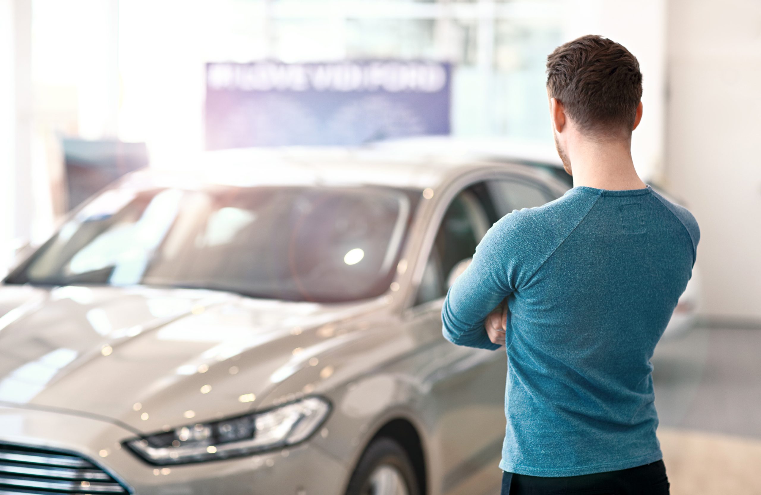Man looking at car in Phoenix car dealership