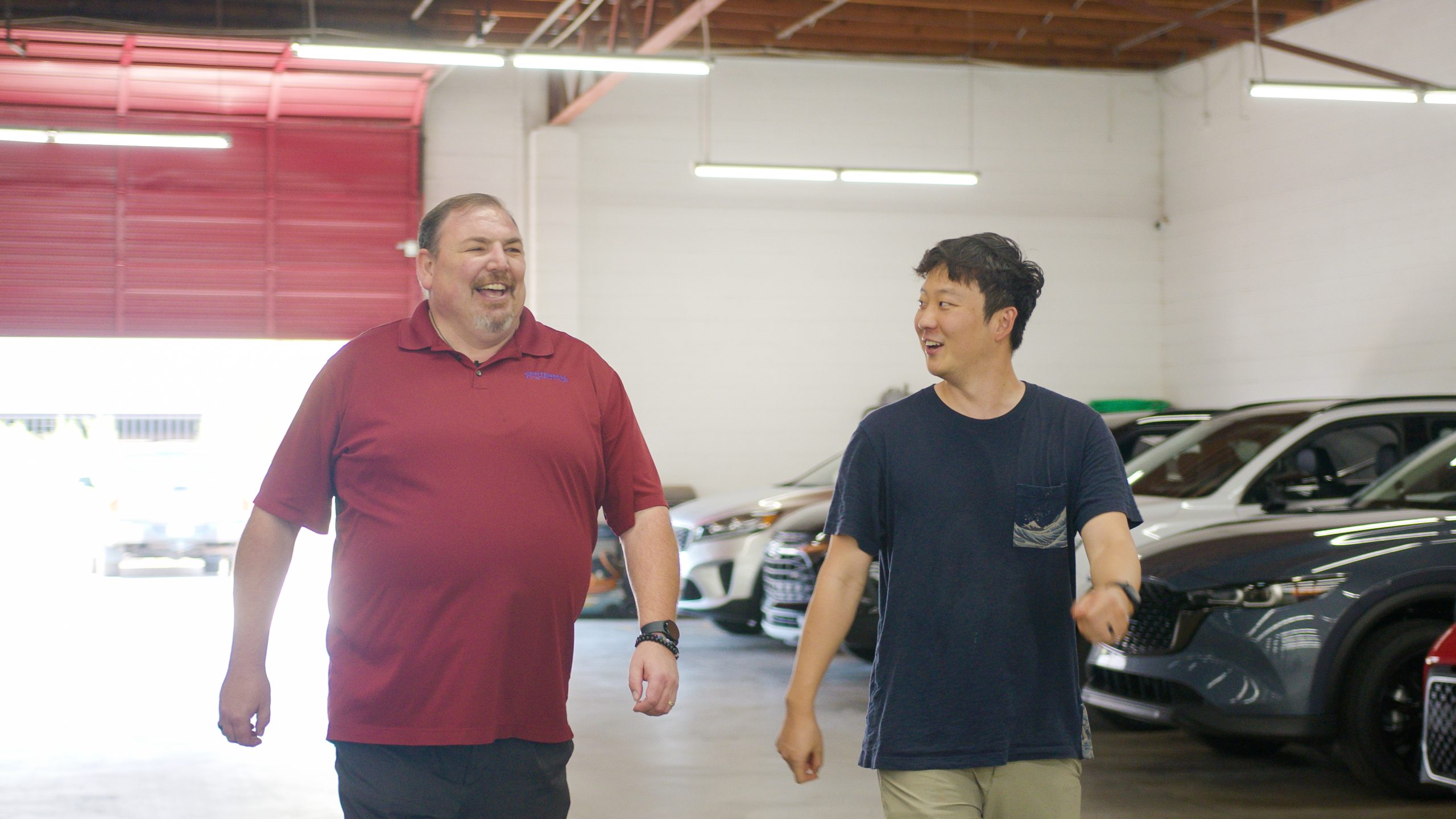 Auto broker showing client a selection of used cars for sale